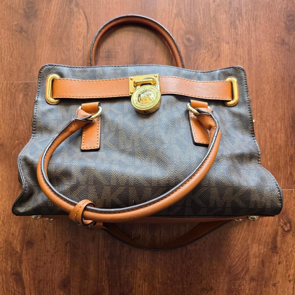 Brown in gold michael kors purse all over print. had some lipstick stains on the